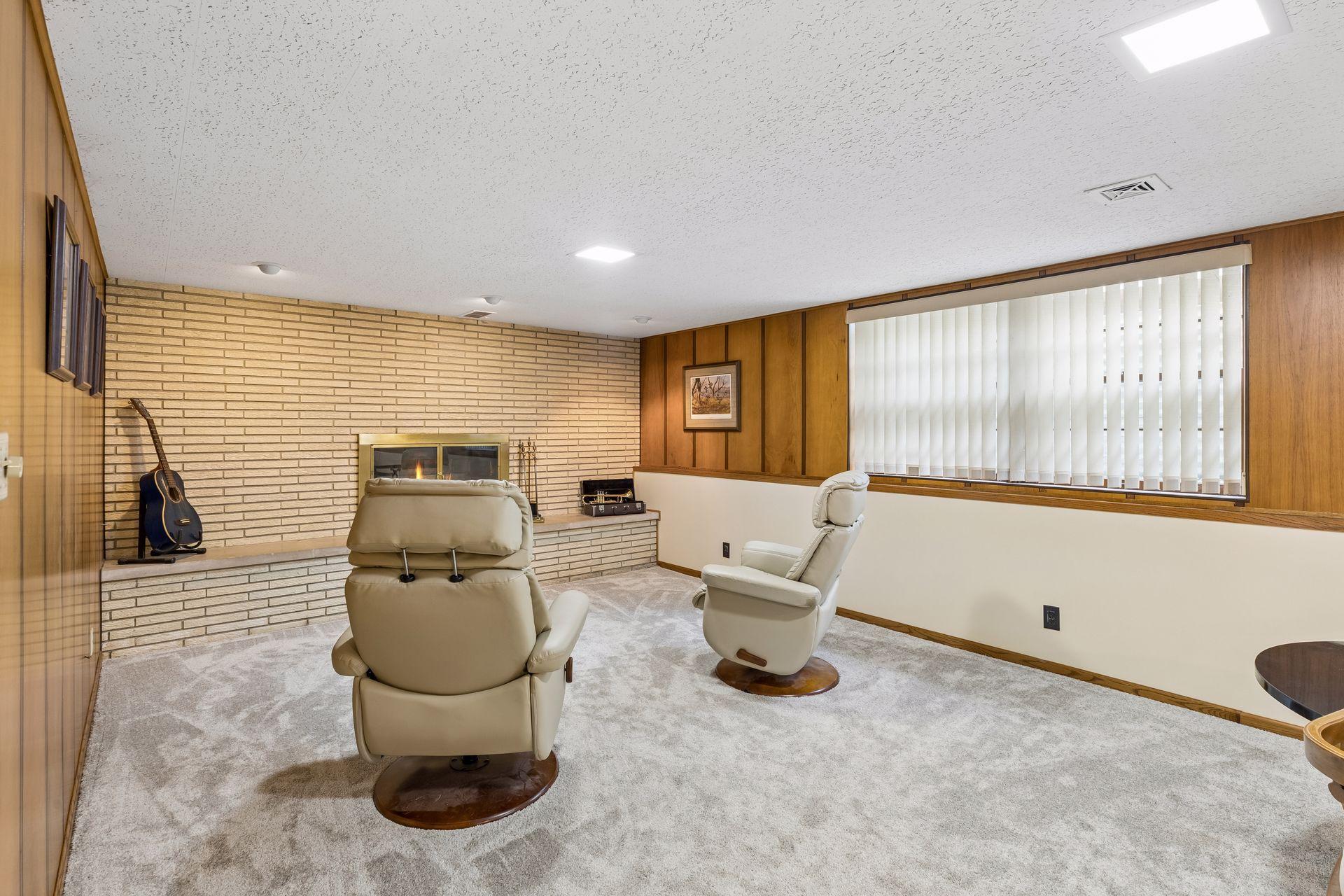Lower level family room with brick accent fireplace.