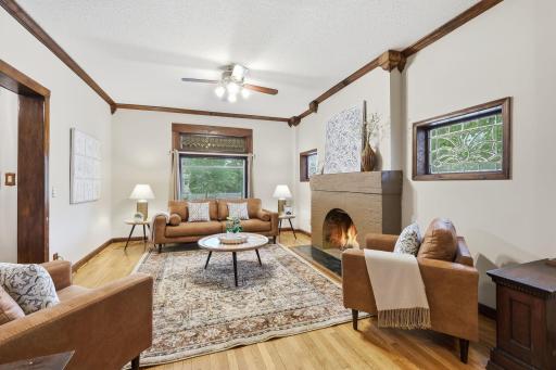 Main level living room with solid wood floor and wood burning fireplace