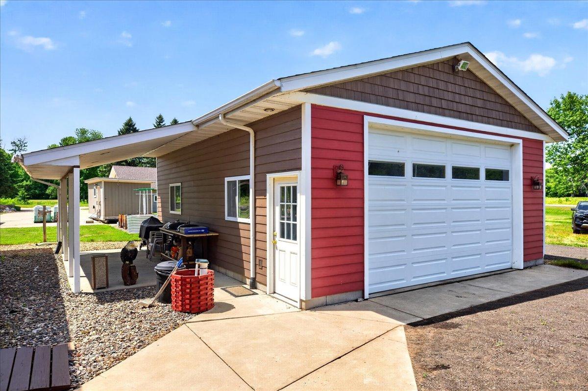 2 car garage next to the house with covered side area.