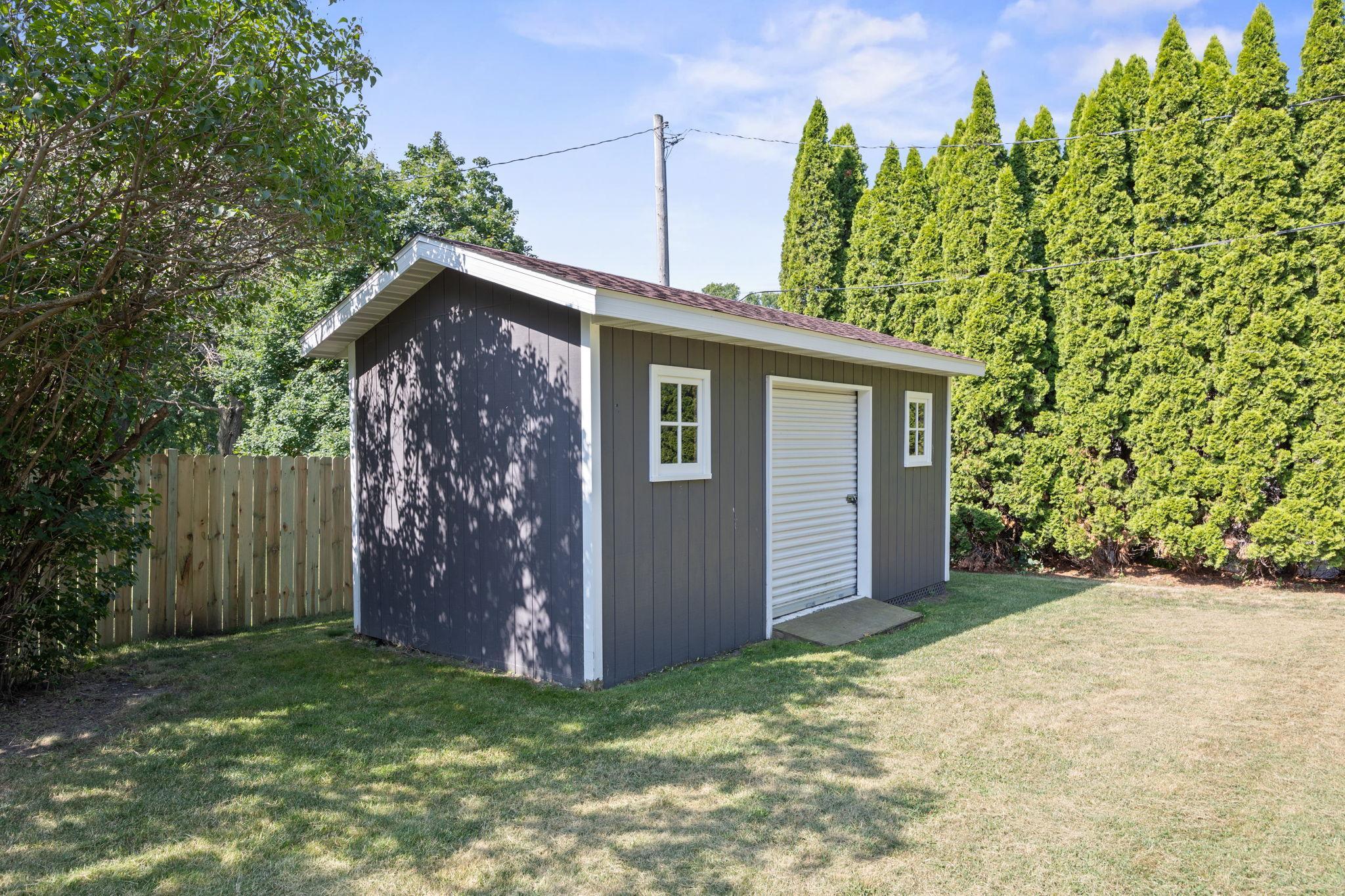 10'x20' stprage shed with roll up door offers tons of space for all your yard tools and toys
