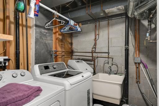 This townhome has a large laundry area with a sink.