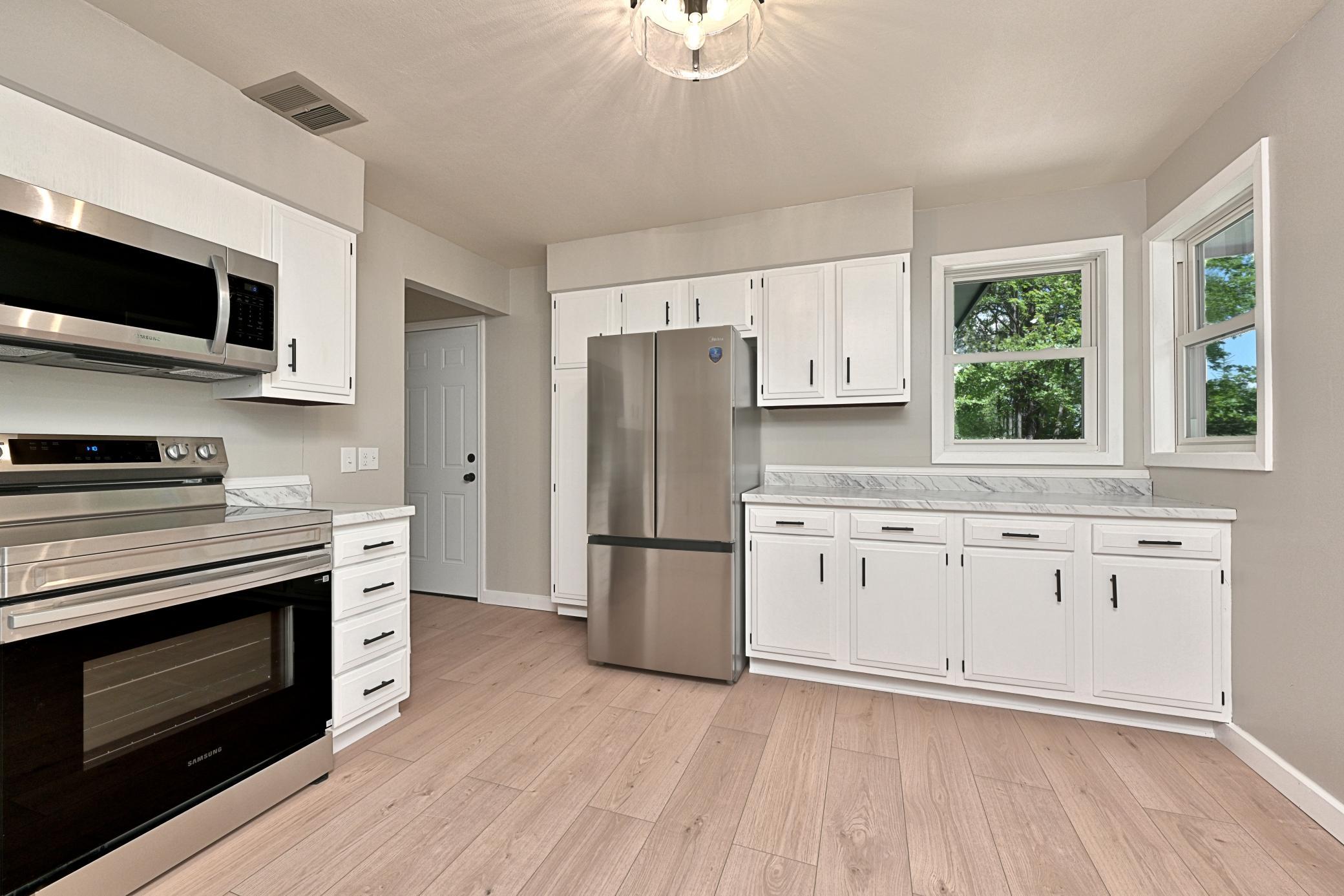 KITCHEN AND DOOR LEADING IN FROM ATTACHED GARAGE.jpg