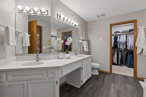 Beautiful large updated primary bathroom offers a big vanity with NEW QUARTZ countertops, fixtures and LVP flooring.