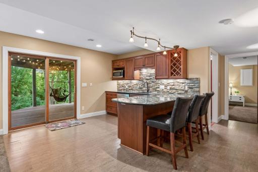 Enjoy a secondary kitchen/wet bar area with lots of cabinetry, granite countertops and an eating space too.