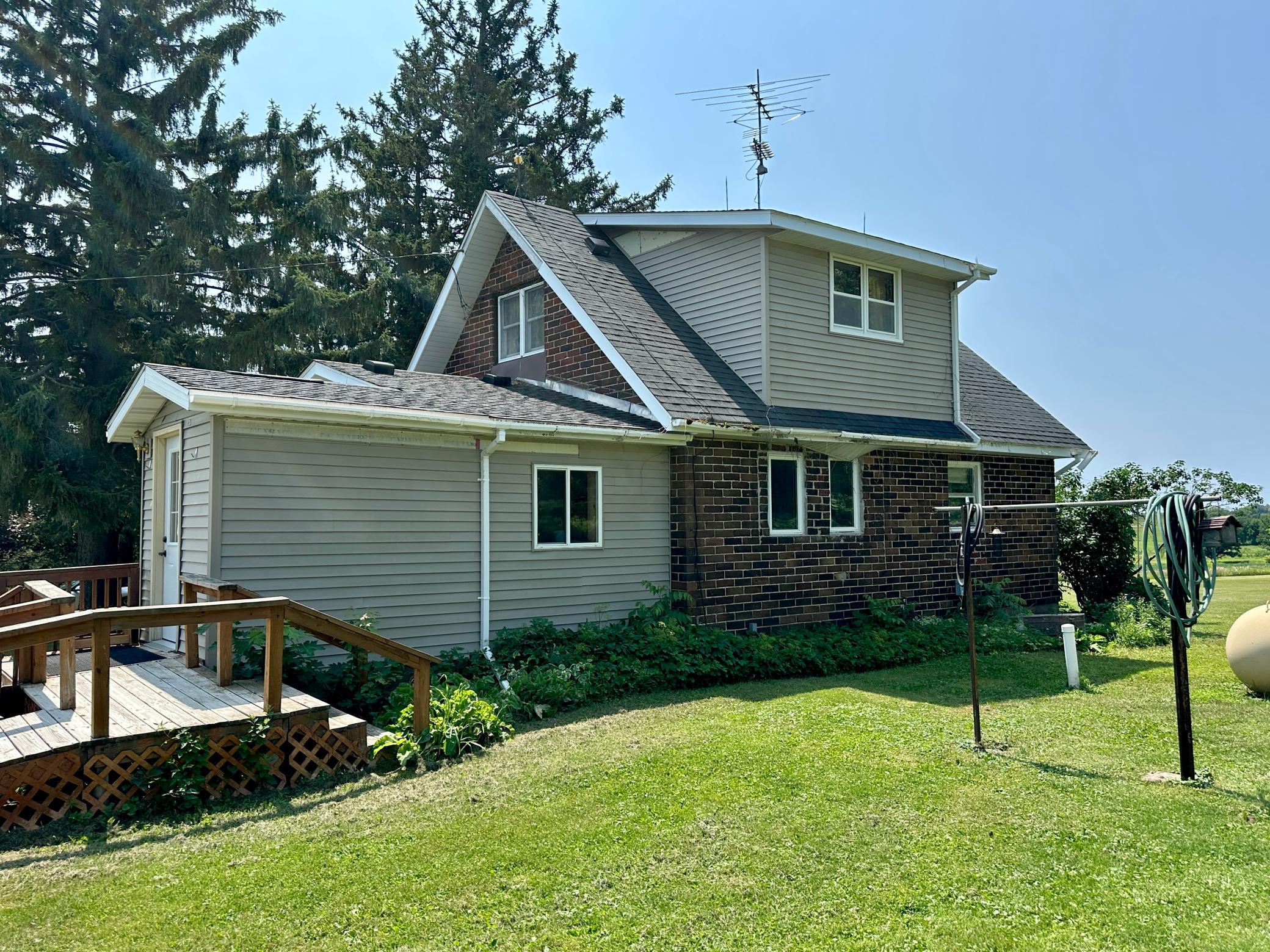 The homes exterior is finished with brick and vinyl siding and gutters.