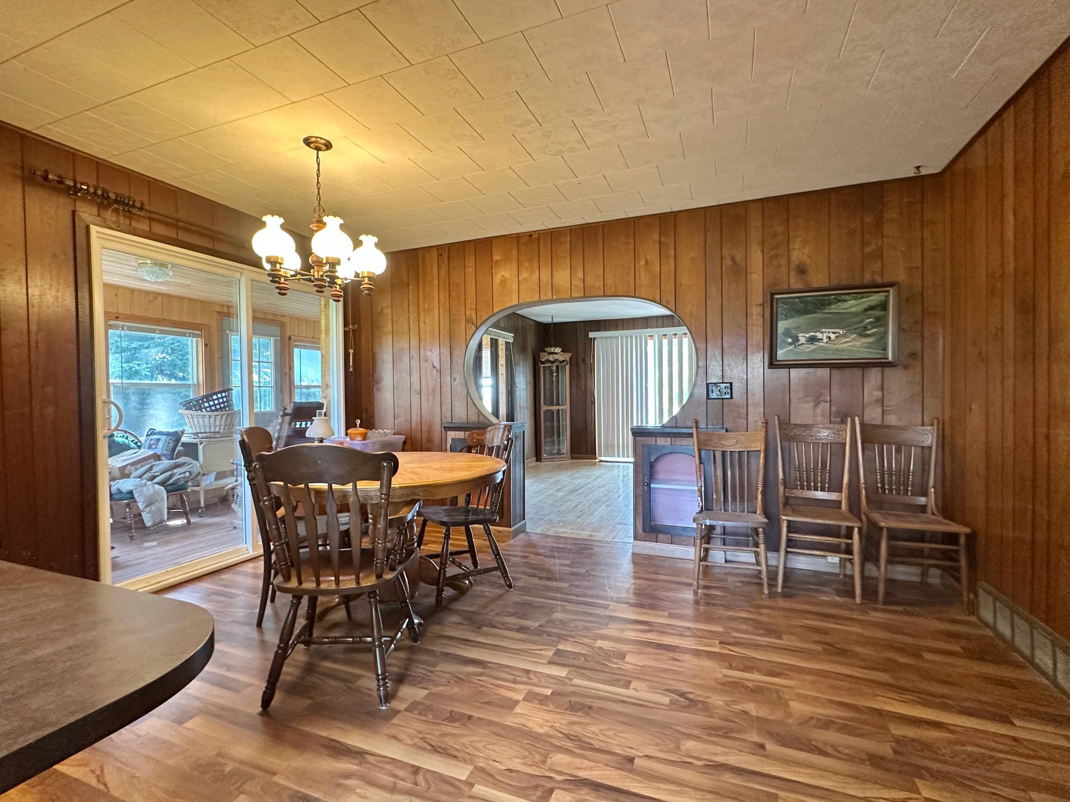 Just off the kitchen is the large dining area. To the left is the sunroom and in the back is the living room.
