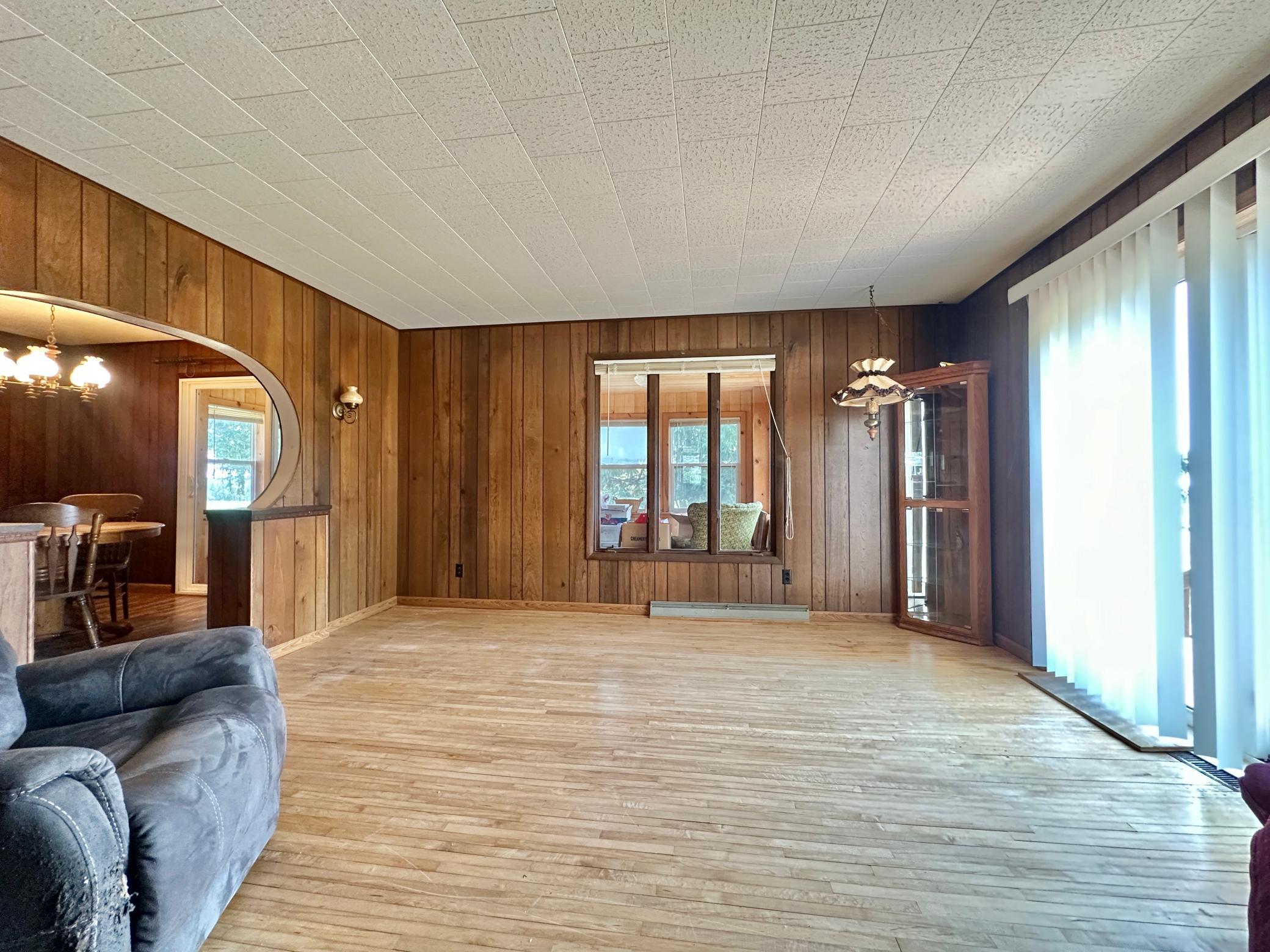 Another living room view with the dining room to the left and the extension of your living space and deck to the right.