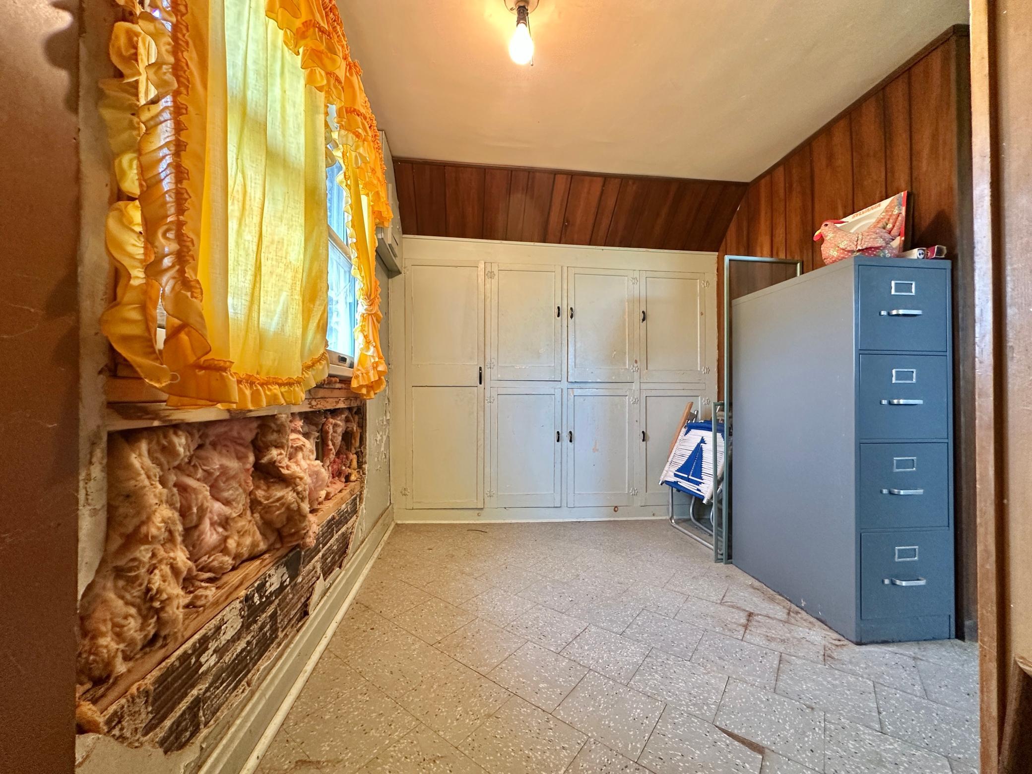 Upstairs needs some fixes and updates, bring your thoughts and ideas. This is a storage room at the top of the stairs with built in cupboards.