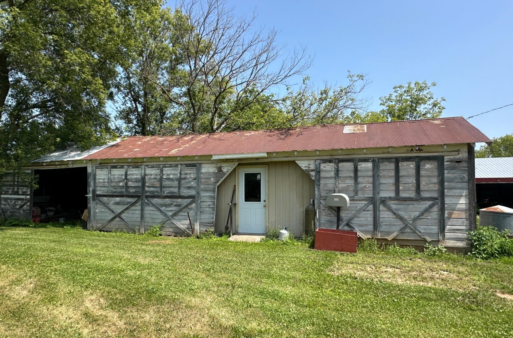To the left covered storage and inside the service door is a former work shop.