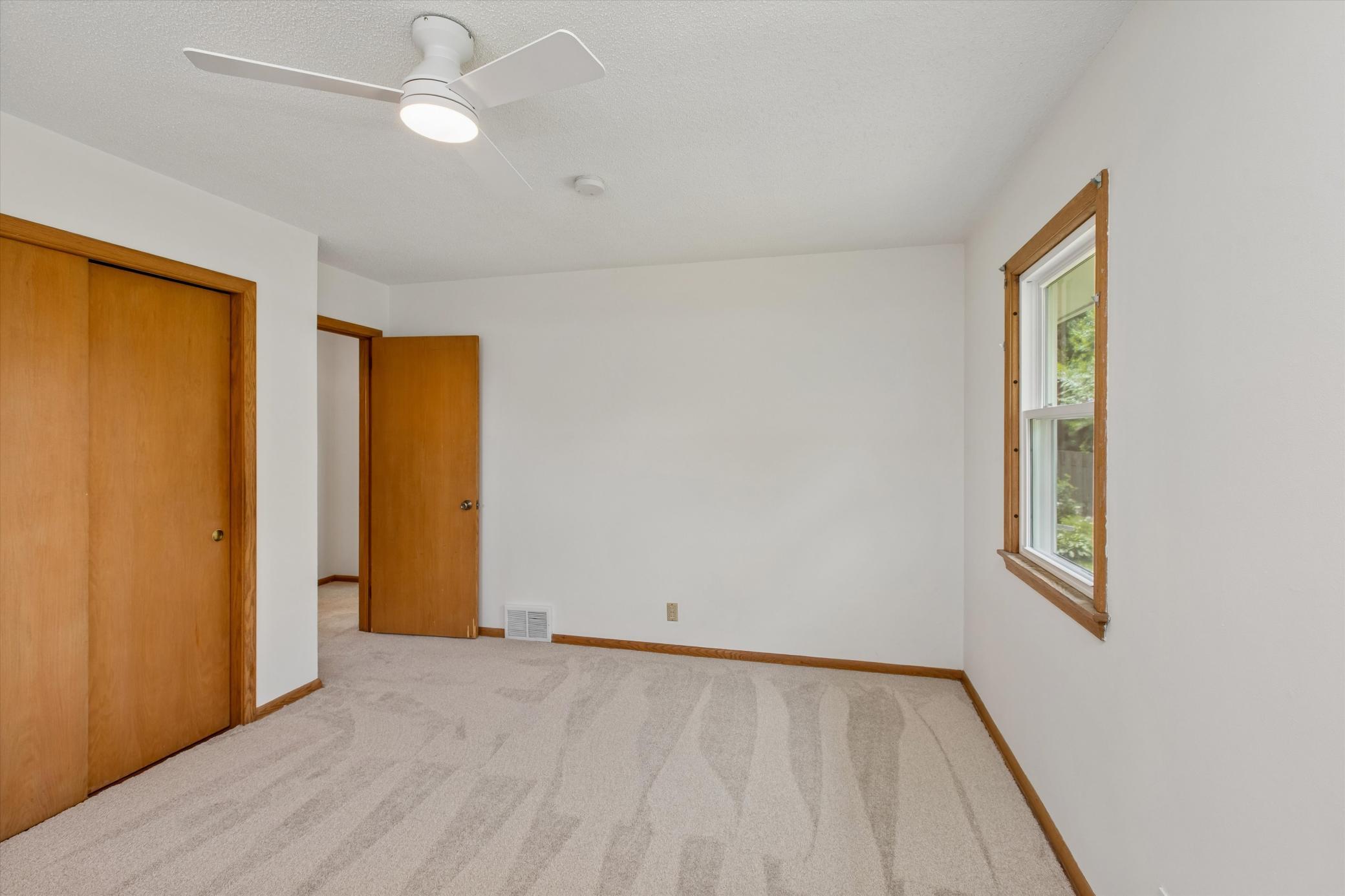Primary bedroom with ceiling fan to keep the air moving