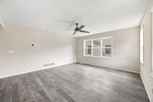 Spacious main floor living area with excellent natural light, laminate flooring and knockdown ceilings