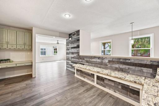 Isn't this FUN?!?! Built in bench seating with barnwood, laminate floors, recessed lights and neutral paint! This is great for entertaining or hosting! Lots of extra seating!