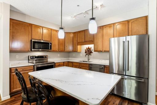 Exceptional kitchen space with upgraded Corian counters, Stainless steel appliances, light fixtures and hardware. The perfect space for the chef in your home with sitting area