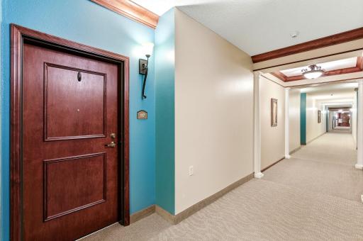 An attractive wide hallway leads to the entry and common spaces.