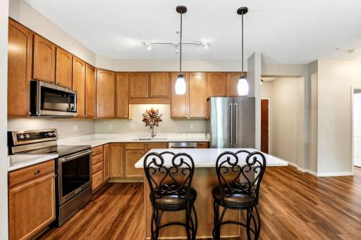 Abundant cabinetry and a center island with seating area
