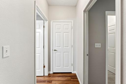The hall to your bedroom, linen closet storage and a full bathroom