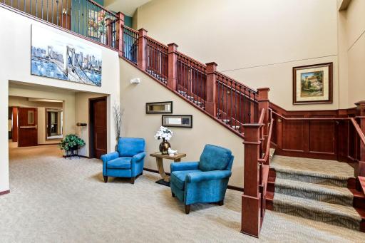The attractive open staircase at the building entry leads to the 2nd floor that has a small library and craft room.