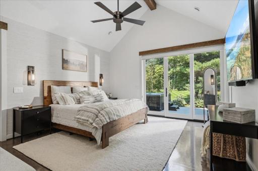 Primary suite with vaulted ceiling and back patio access.