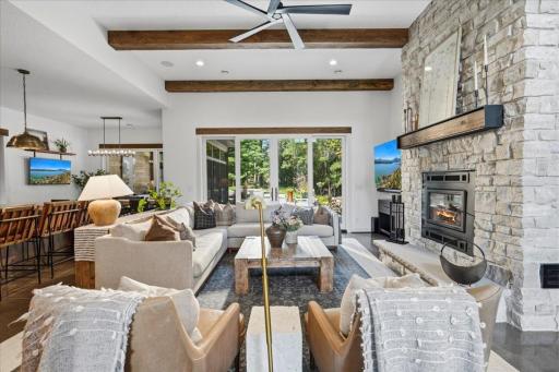 High ceilings with natural wood beams and ample sunlight.