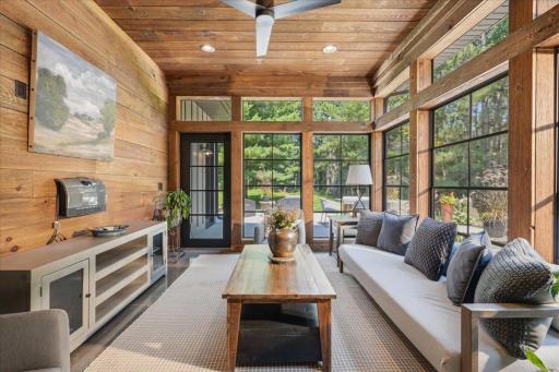 Sunroom offers nature views and additional relaxation space.