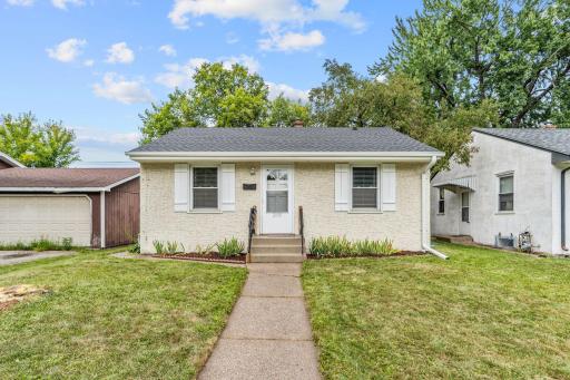 Cute sidewalk leads to the front of the home.