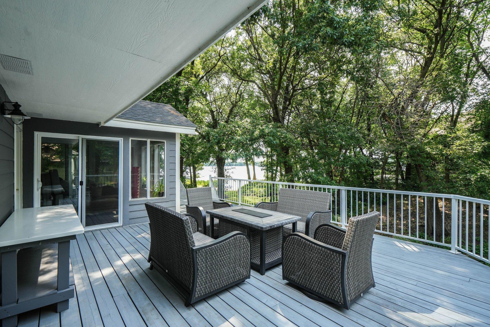 View from the deck shows the lake views and access through the sliding glass door into the sunroom.