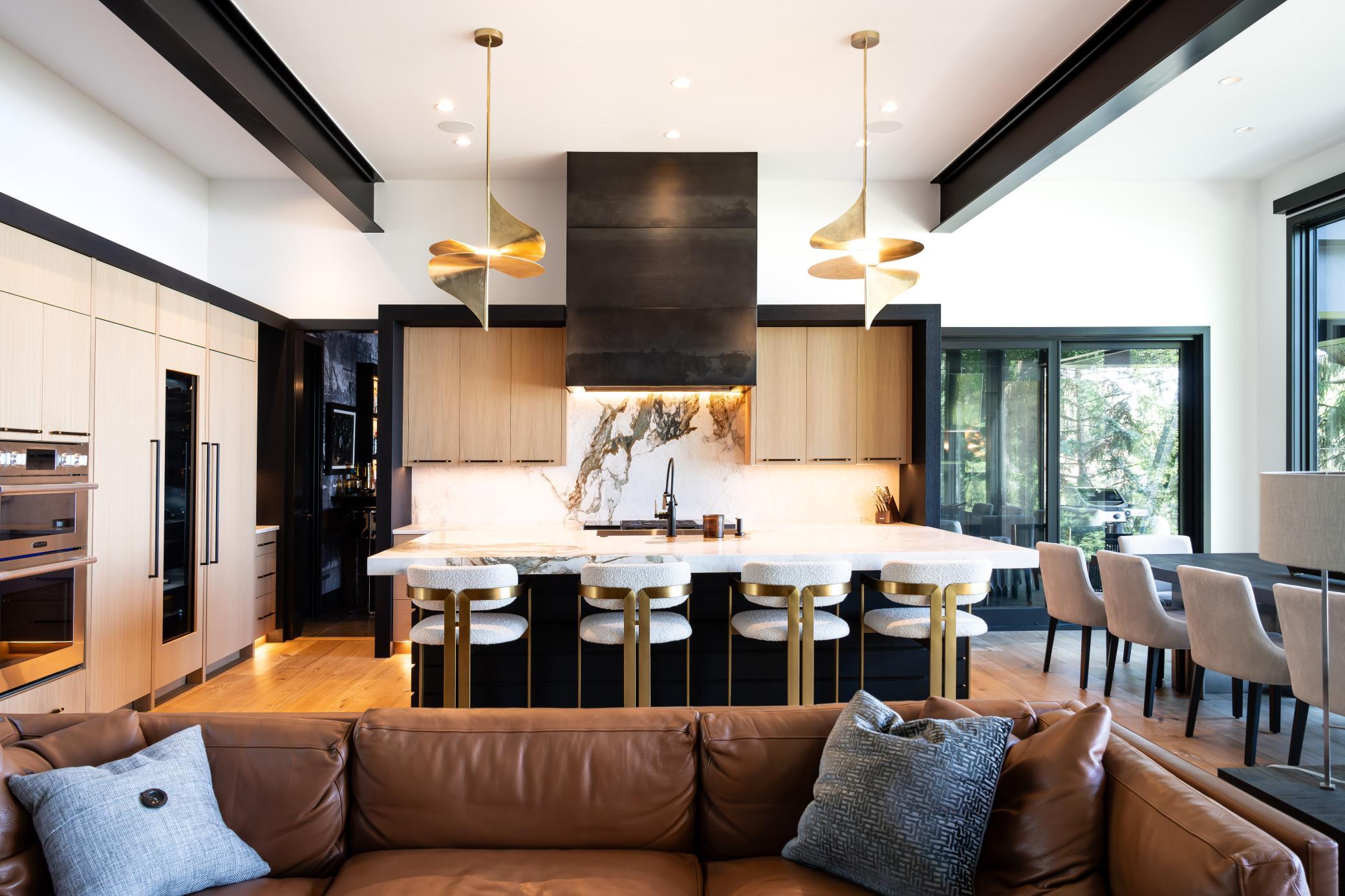 Custom Entertainer's Kitchen featuring stunning cabinet details, gorgeous light fixtures and marble countertops. Center island is 11' x 5'
