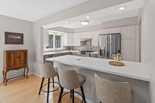 Pull up a stool at the oversized breakfast bar, the perfect spot for morning coffee or casual conversation while dinner's on the stove.