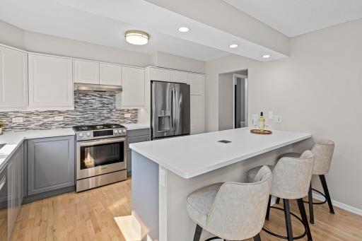 Two-tone cabinetry and a expansive island give this kitchen a sophisticated, move-in-ready feel with room for everyone to gather.