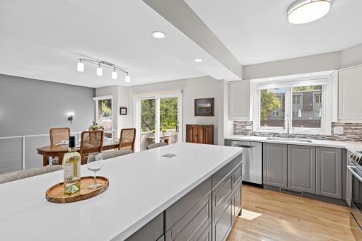 Natural light and an open layout connect the dining area to the kitchen and deck beyond a floor plan built for togetherness.