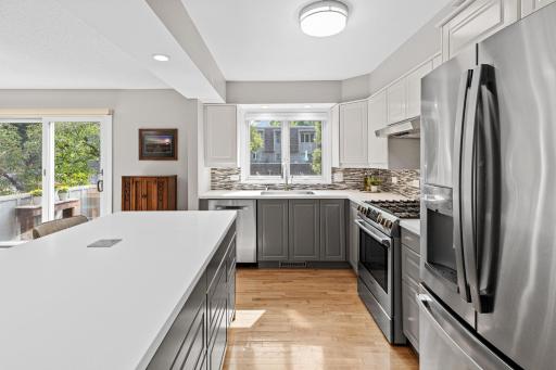Sleek stainless appliances and a designer tile backsplash bring a modern edge to this thoughtfully updated kitchen.