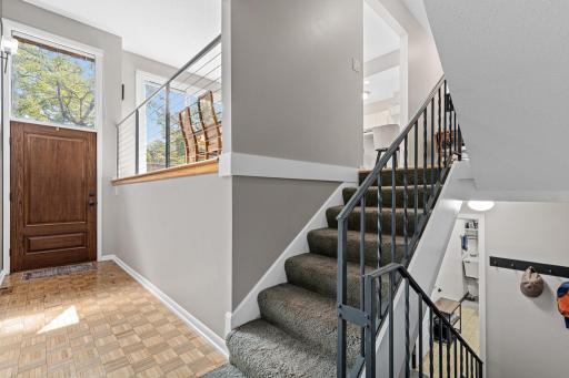 Sleek cThe open staircase adds a modern touch to this multi-level home's flow between spaces.