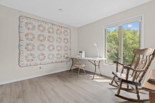 New flooring and a bright window view make this quiet, versatile space easy to imagine as your own creative retreat.