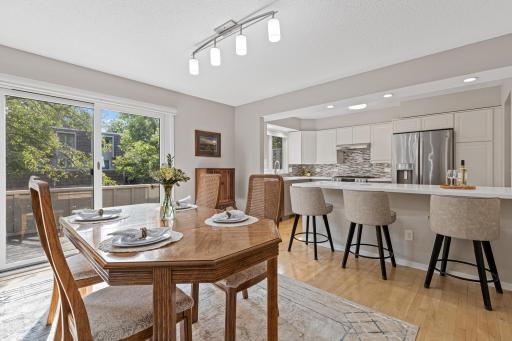 The dining space flows effortlessly into the open kitchen, with sliding glass doors just steps away for easy indoor-outdoor entertaining.