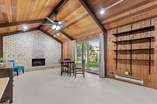 Gather around the brick, wood-burning fireplace beneath soaring vaulted ceilings, a cozy focal point perfect for quiet evenings in.