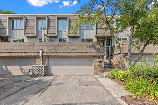 Photo for 10304 Berkshire Road, Bloomington, MN 55437 - listing #7116040 Arrive home through a private brick entryway, where layered rooflines and natural materials set a warm, architectural tone before you even step inside.