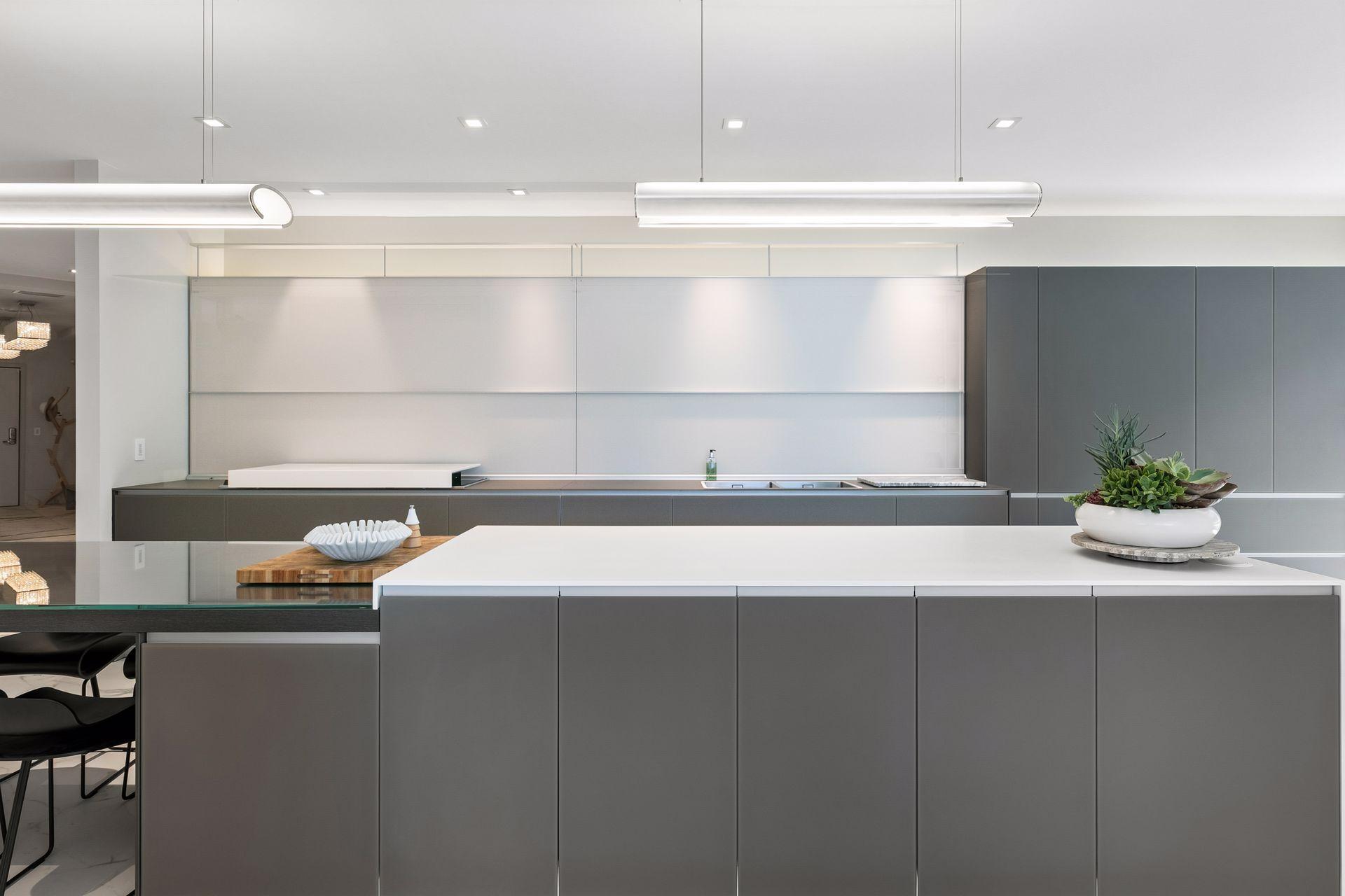 Designed for both beauty and function, this striking Valcucine kitchen features clean lines, expansive surfaces, integrated cabinetry, and a statement-making island at the heart of the home.