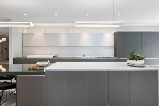 Designed for both beauty and function, this striking Valcucine kitchen features clean lines, expansive surfaces, integrated cabinetry, and a statement-making island at the heart of the home.
