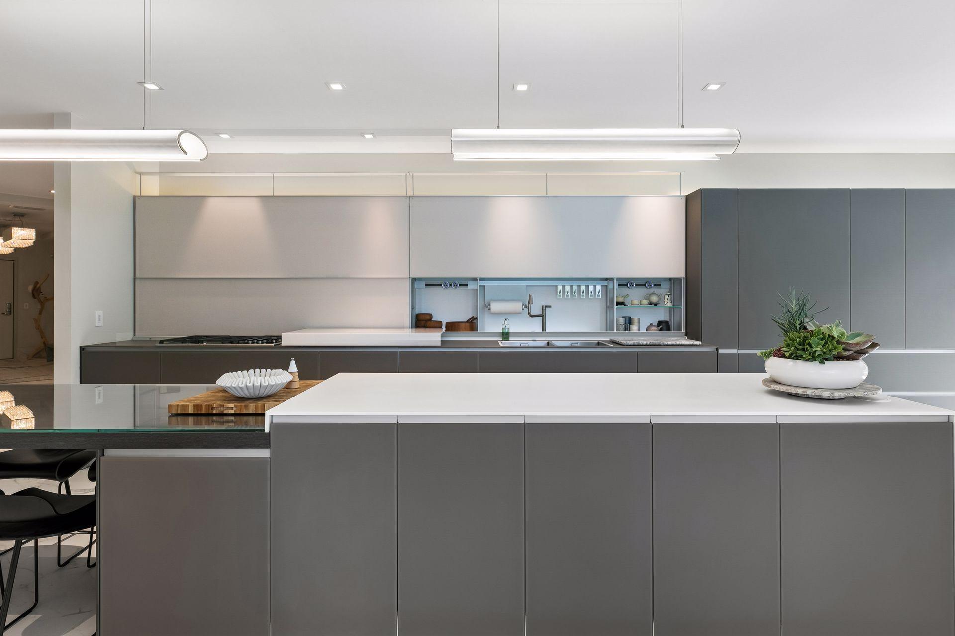 Designed for both beauty and function, this striking Valcucine kitchen features clean lines, expansive surfaces, integrated cabinetry, and a statement-making island at the heart of the home.