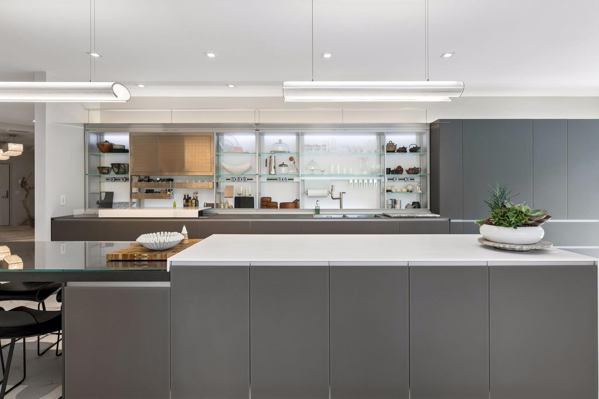 Designed for both beauty and function, this striking Valcucine kitchen features clean lines, expansive surfaces, integrated cabinetry, and a statement-making island at the heart of the home.