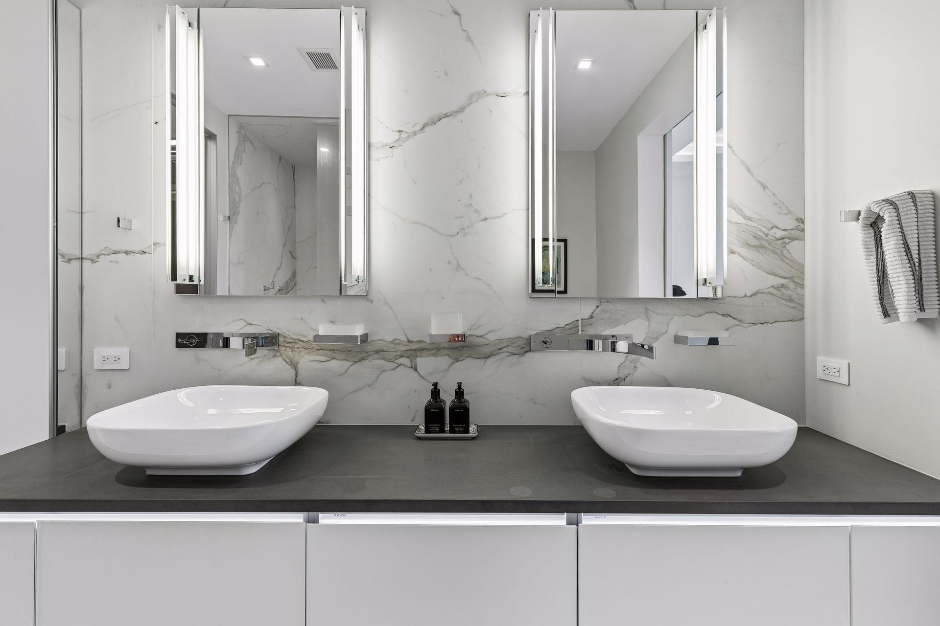 Porcelain walls, double sinks, and floating vanity add style