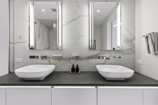 Porcelain walls, double sinks, and floating vanity add style