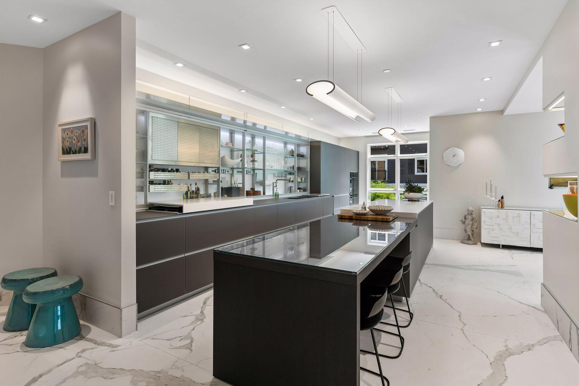 A stunning expression of Italian design, this Valcucine kitchen pairs sleek, streamlined cabinetry with a dramatic oversized island and sophisticated contemporary finishes.