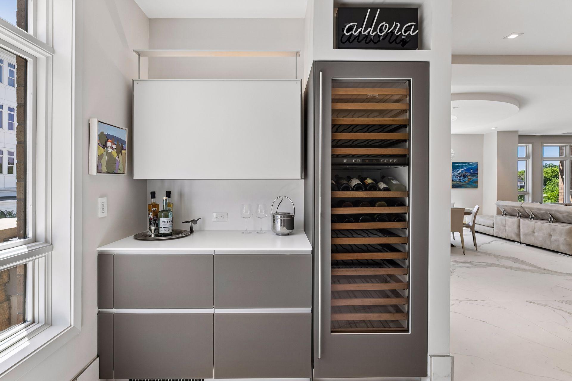 Stylish bar area off the kitchen with full beverage fridge and counter space with extra storage