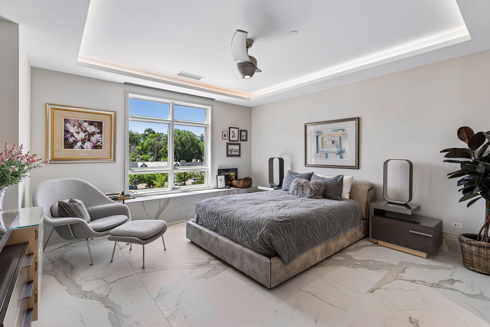 Step into the luxurious primary suite with porcelain flooring throughout, Lutron remote blinds, and stylish fixtures