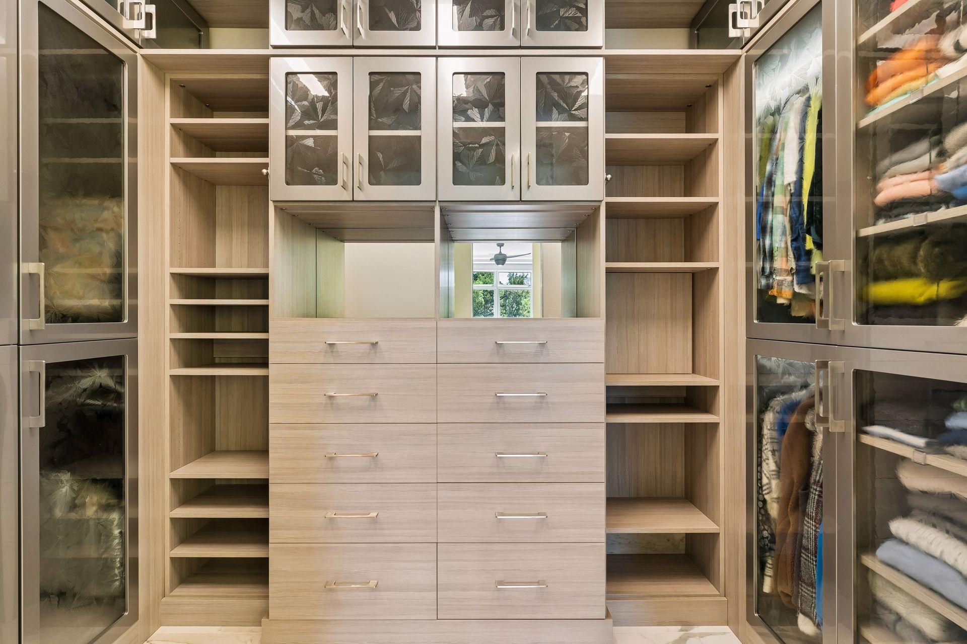 Walk-in closet with pocket door opening to the laundry room