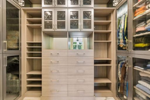 Walk-in closet with pocket door opening to the laundry room