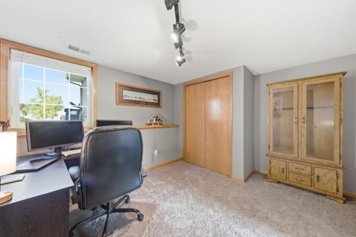 The lower level and fourth bedroom which is being used as an office.