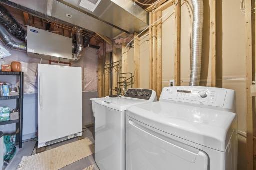 The laundry room is located in the utility room which has a brand new furnace. The freezer is not included in the sale.