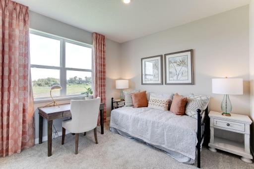 The main level bedroom would also be a great office space. Photo of model home, colors and finishes will vary.